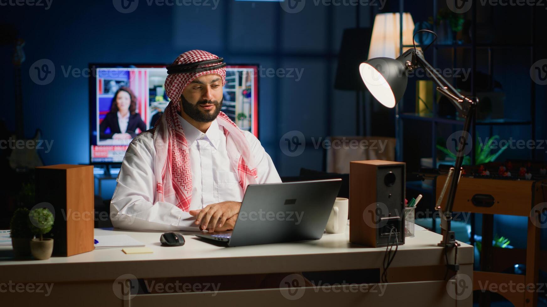 Arab job candidate remotely being interviewed by human resources team while at home. Muslim man getting his credentials checked during online video conference meeting before being employed photo