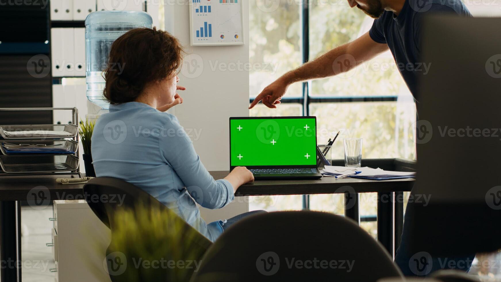 Startup team checking greenscreen app on laptop layout, brainstorming new budget ideas and working on business operations. Colleagues discussing at desk, isolated chromakey display. photo