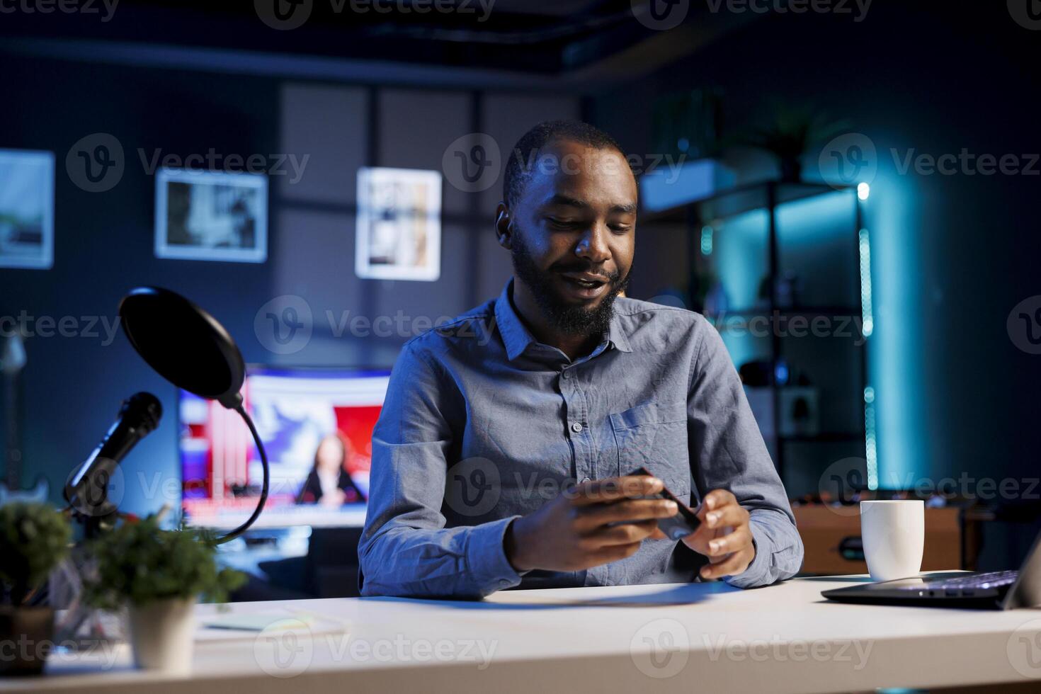 African american man filming tech tutorial on how to do maintenance on broken mini RGB lights. Technology internet show host teaching subscribers how to open and fix video production tool photo