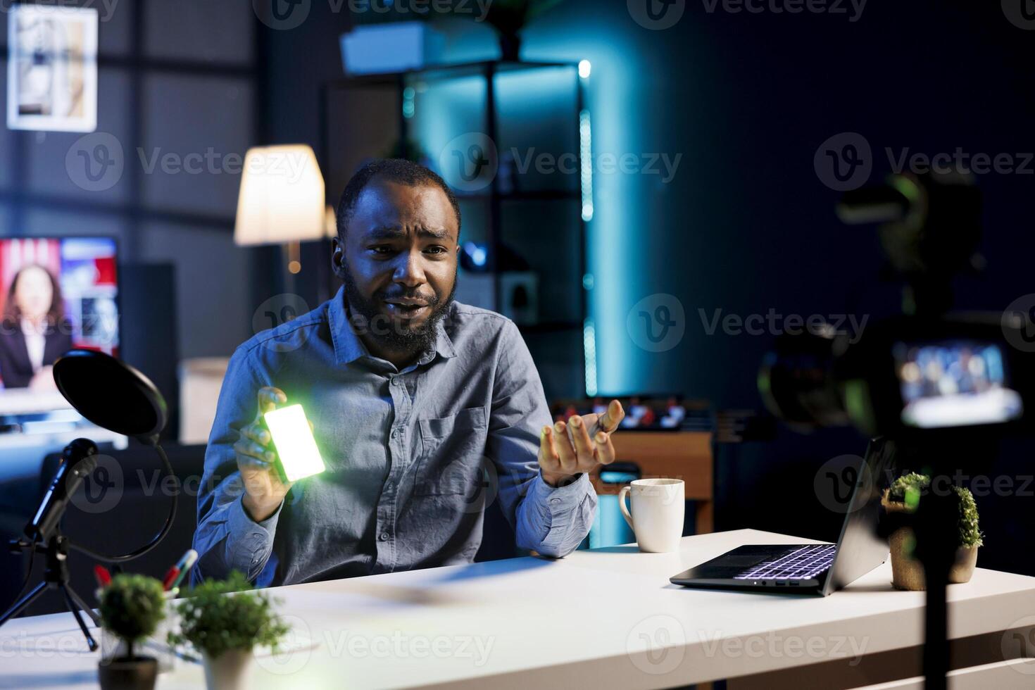 Influencer reviewing mini RGB lights, satisfied with high quality color rendering coming from it. Media star filming content for online channel, excited about excellent video production tool photo