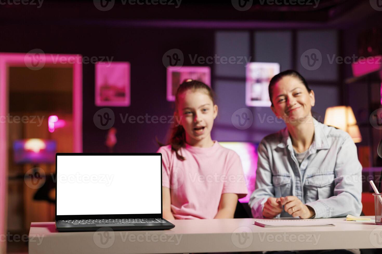 Little girl and her mother filming sponsored content, unboxing newly released mockup laptop to make fans buy it. Kid and mom advertising product, presenting isolated screen notebook to subscribers photo