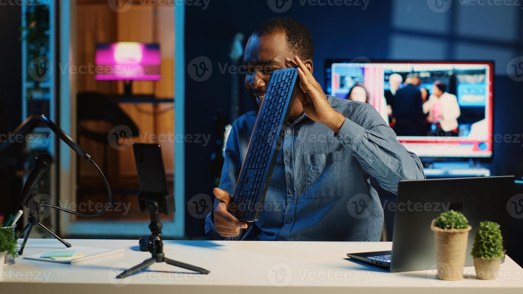 African american technology internet star filming review of newly released keyboard and mouse set, greeting audience and presenting them feedback about sensor sensitivity, doing endorsement photo