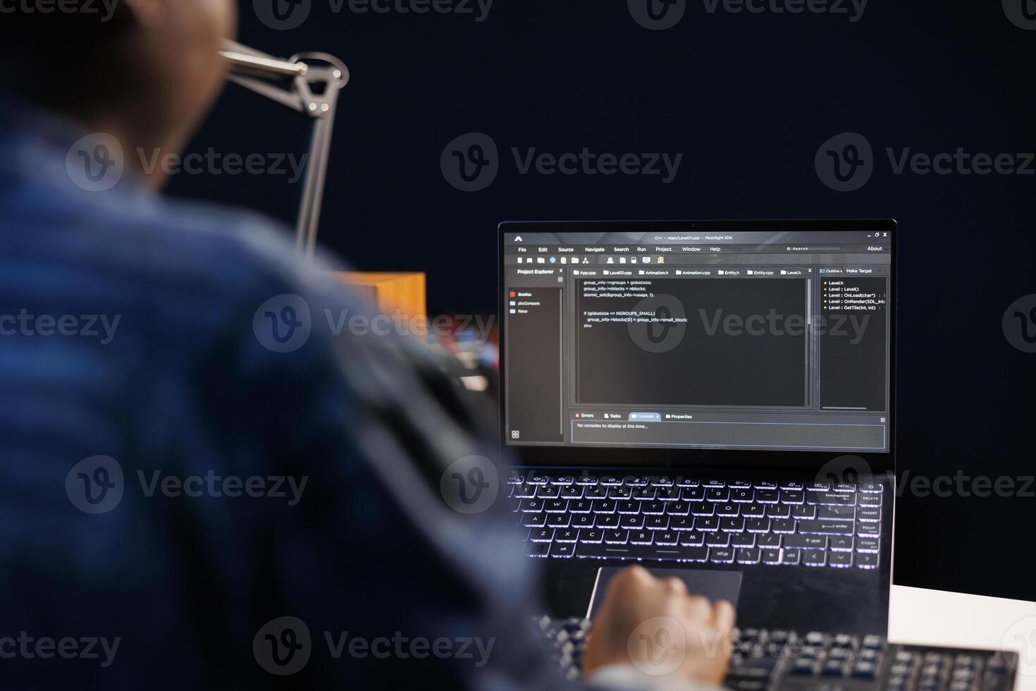 African American developer managing a system, typing on keyboard and laptop screen showing software programming. Professional freelancer working on data center and network security. photo