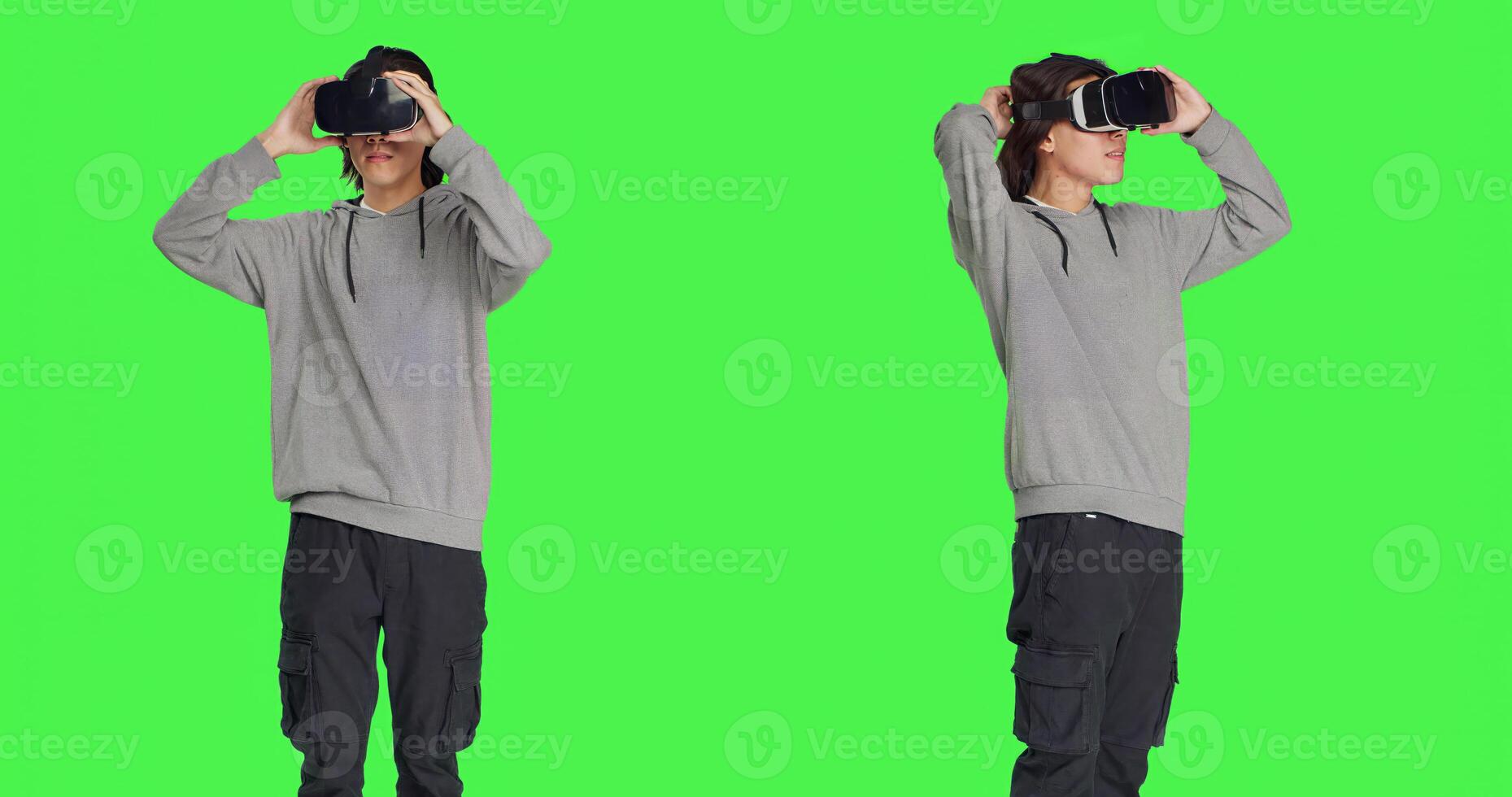 Young adult enjoys virtual reality tech in studio with greenscreen backdrop, using interactive 3d vision on headset. Modern guy having fun with artificial intelligence vr glasses. photo