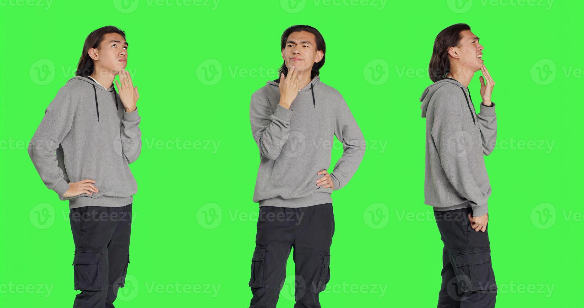 Asian man questioning perspective standing in greenscreen studio, thinking about answer and pondering. Male model in a dilemma trying to focus, pensive uncertain young adult thinker. photo