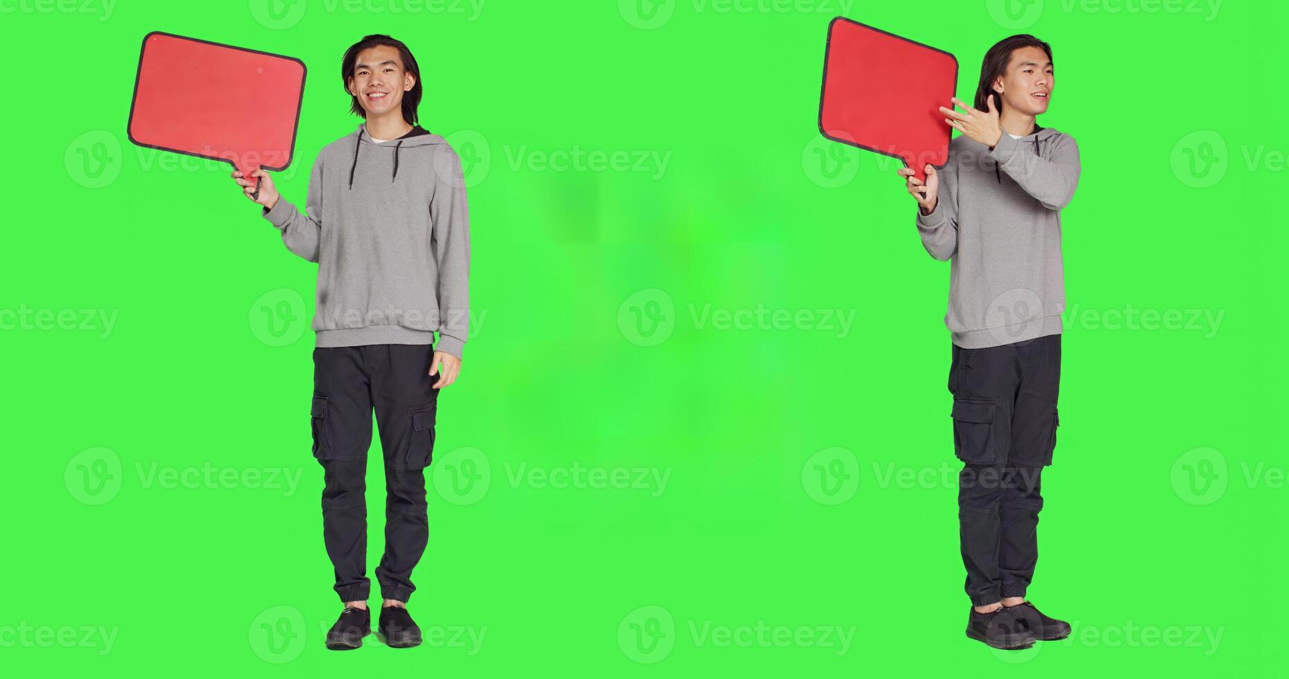 Young guy shows speech bubble in studio, presenting isolated copyspace on billboard icon against greenscreen. Asian man working on creating marketing commercial, advertisement. photo