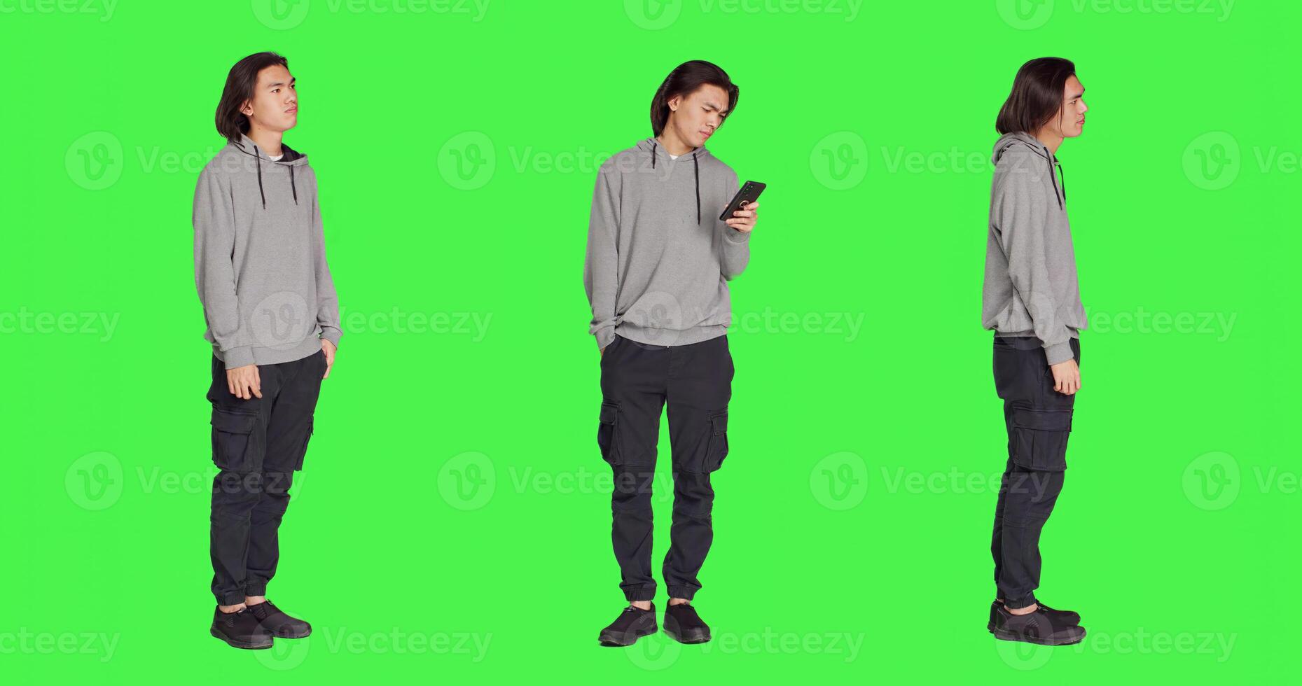 Dissatisfied man in studio awaiting a thing, wandering about and monitoring time on watch against full body greenscreen backdrop. Asian person annoyed and frustrated, looks at his timepiece. photo