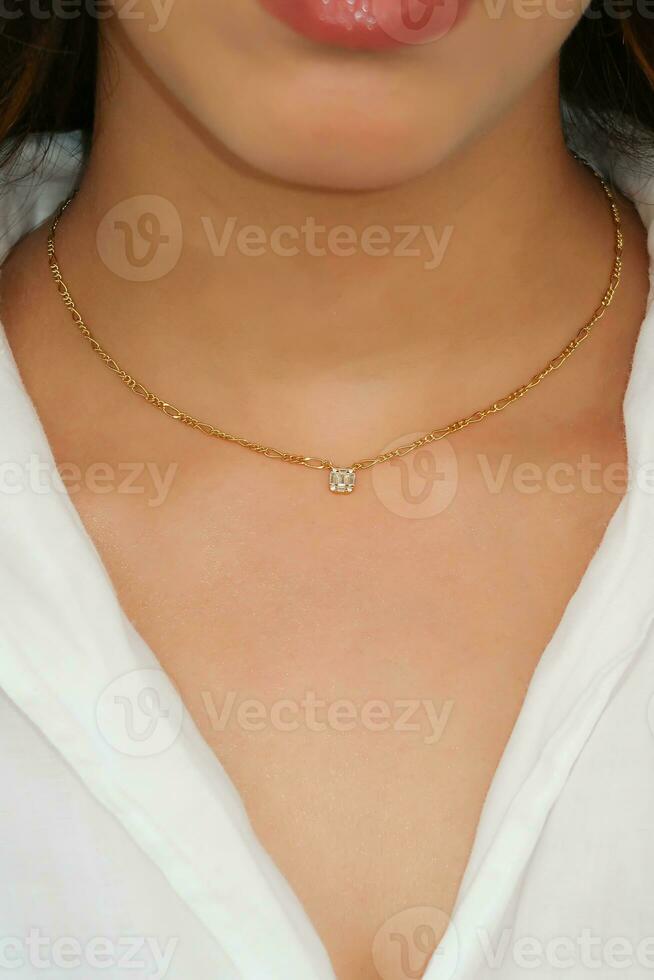 Young woman wearing a Figaro Chain Necklace containing a square zircon. photo