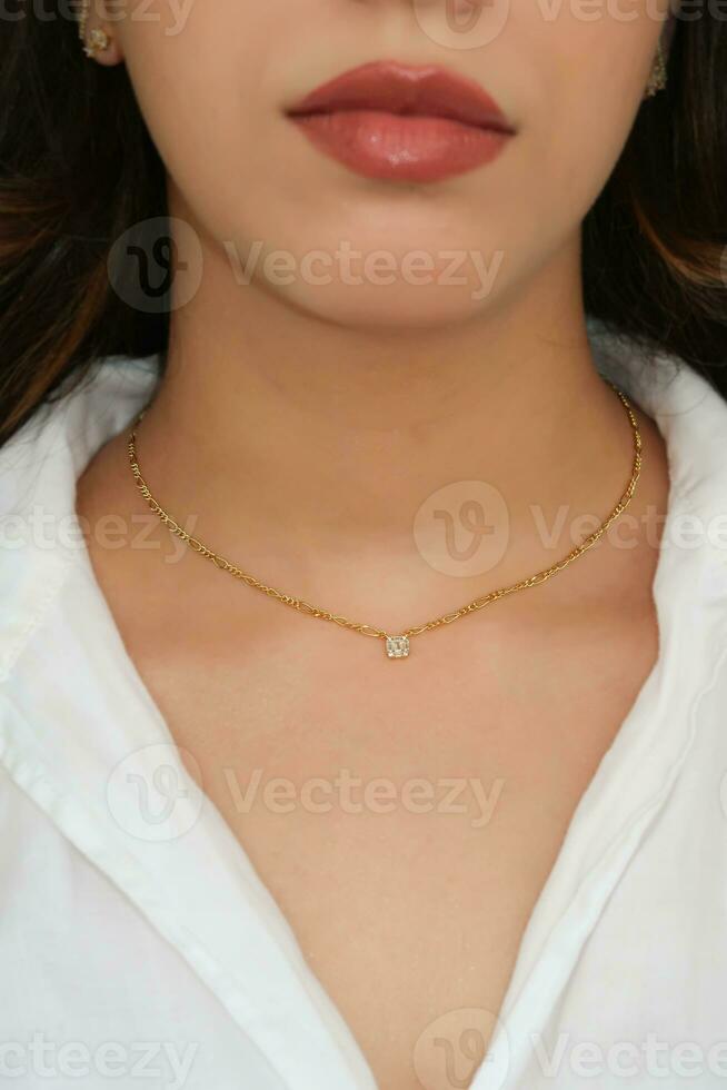 Young woman wearing a Figaro Chain Necklace containing a square zircon. photo