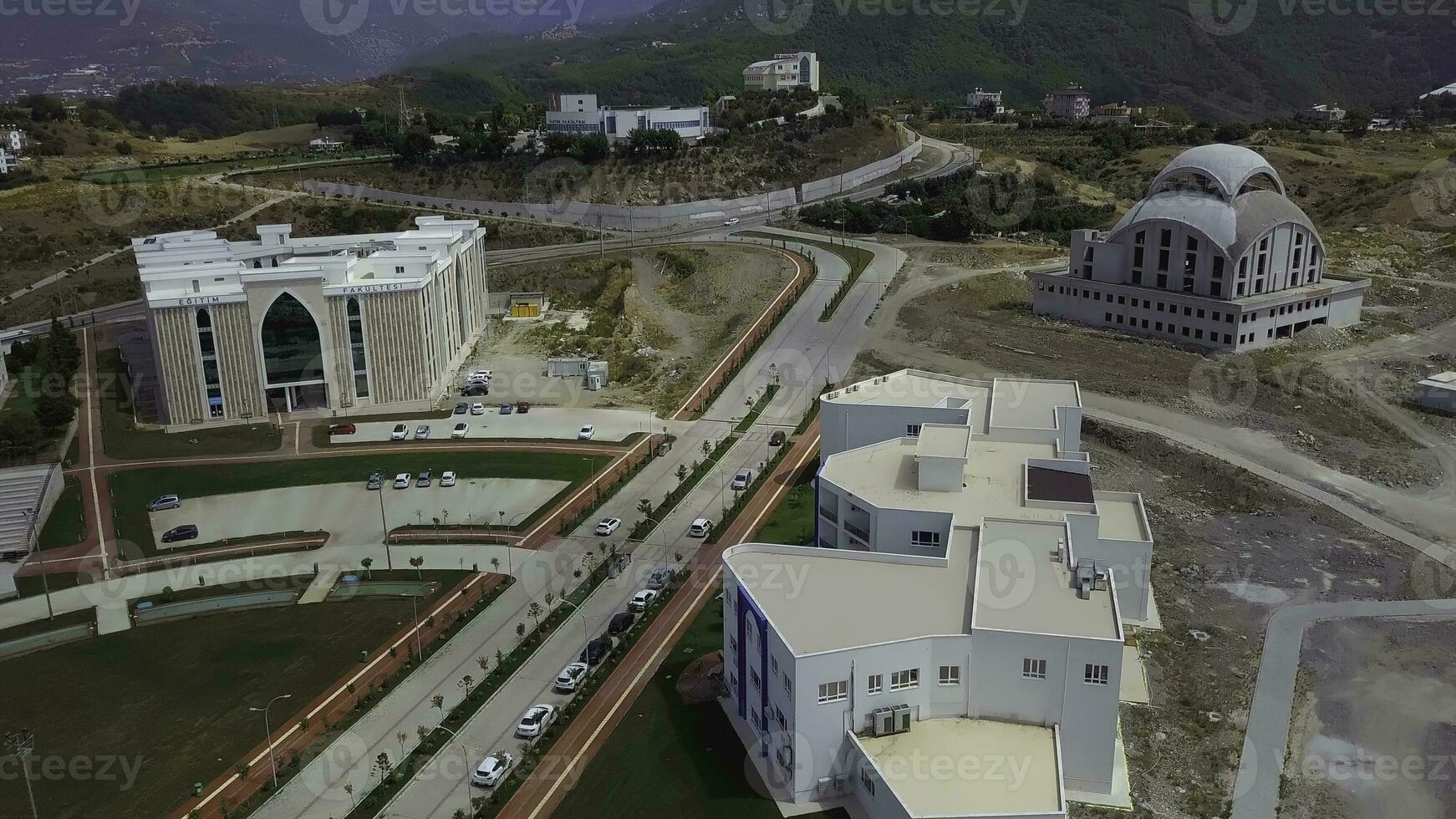 Top view of the city during the day. CLIP. A beautiful suburb with a white mosque. Filmed on a quadcopter from above. Cottage village in the mountains photo
