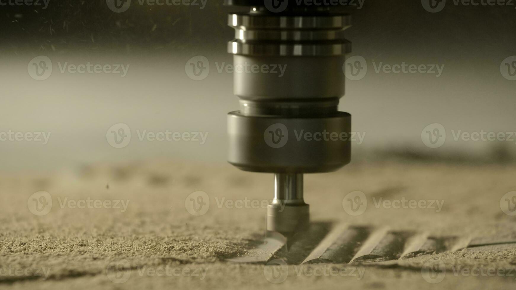 Close up of a carving machine drilling a wooden plank with a flying dust. Creative. Industrial background at the workshop. photo