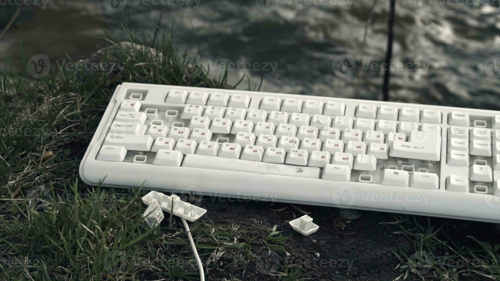 Broken Computer Keyboard. Broken computer keyboard in nature. The concept of technology's adverse impact on the world photo