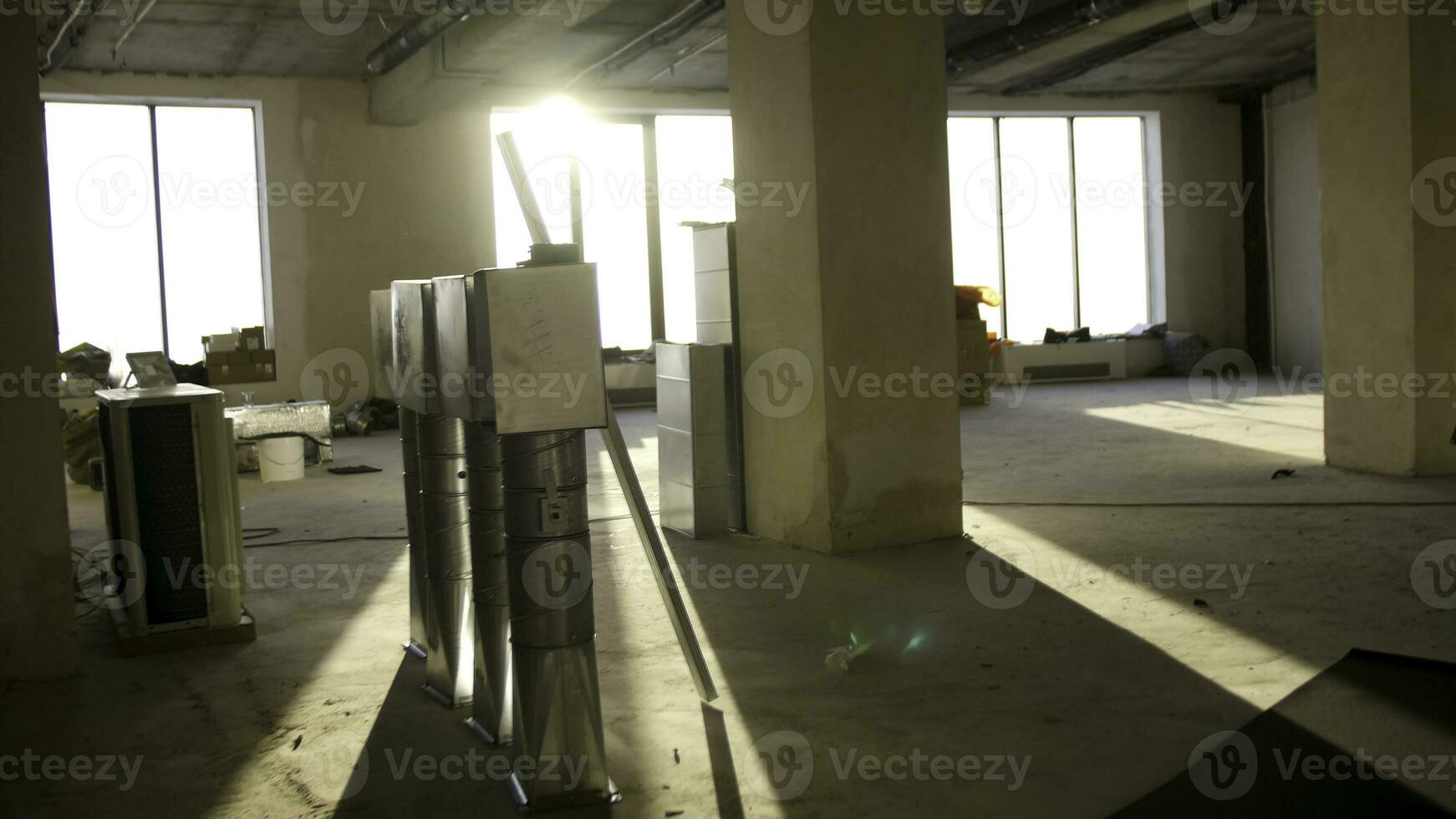 Abandoned empty room in an old factory. Interior of the new room without finishing in the newly built high-rise building photo