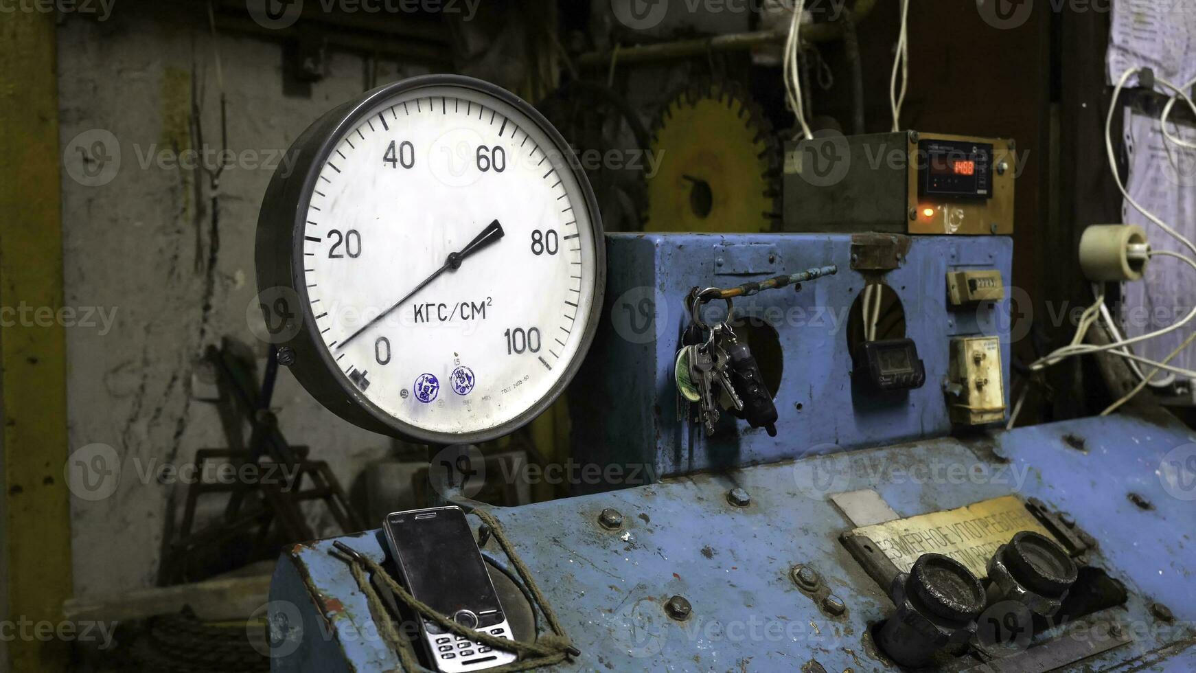 Pressure gauge on control panel. Pressure gauge or pressure indicator stands on old blue control panel operating from key photo