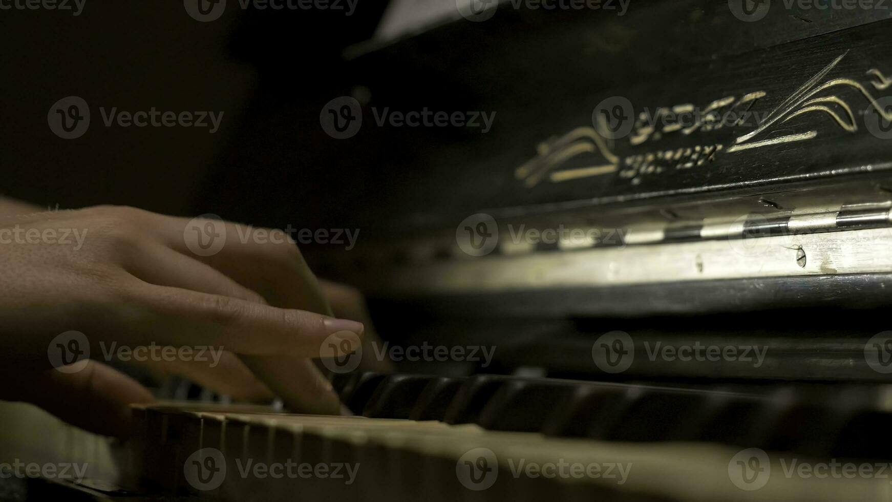 A young woman playing piano closeup. Piano hands pianist playing Musical instruments details with player hand closeup photo