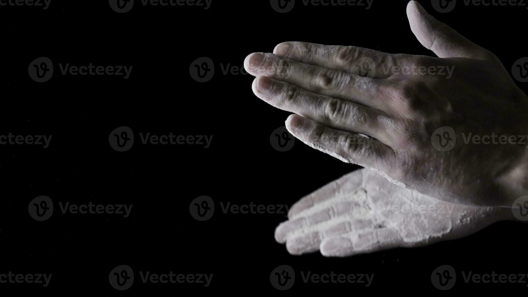 Chef Hands Clapping With Flour In Slow Motion on black background. Frame. Chef Claps Hands Together With Flour, Super Slow Motion photo