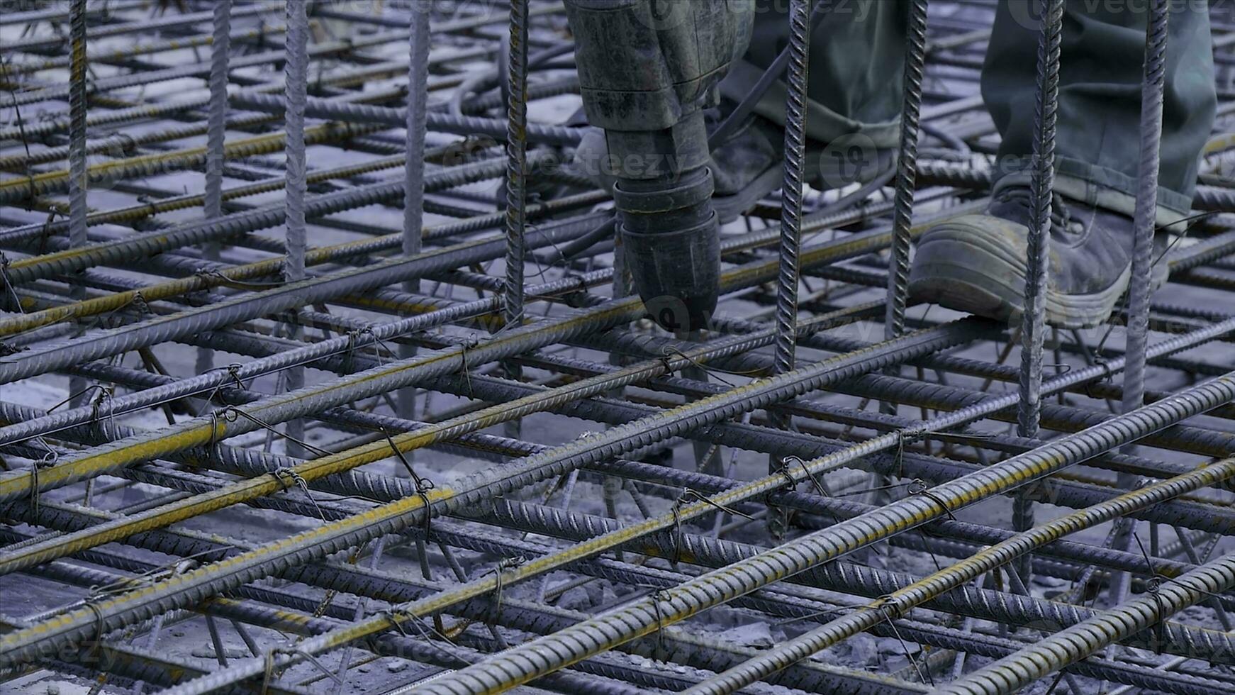 Construction worker. Worker in the construction site making reinforcement metal framework for concrete pouring photo