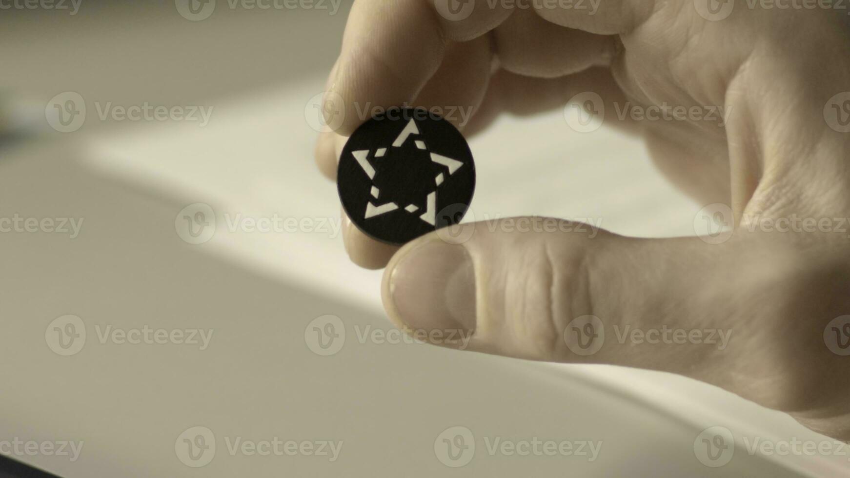 Close up view of a button from a shirt with pattern in the shape of a star photo