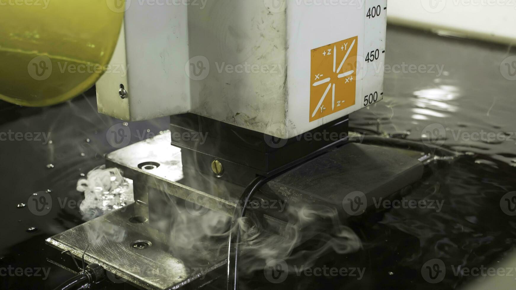 The abrasive water jet machine cutting the aluminium plate. Scene. The modern technology of sheet metal working process by high pressure water jet machine. photo