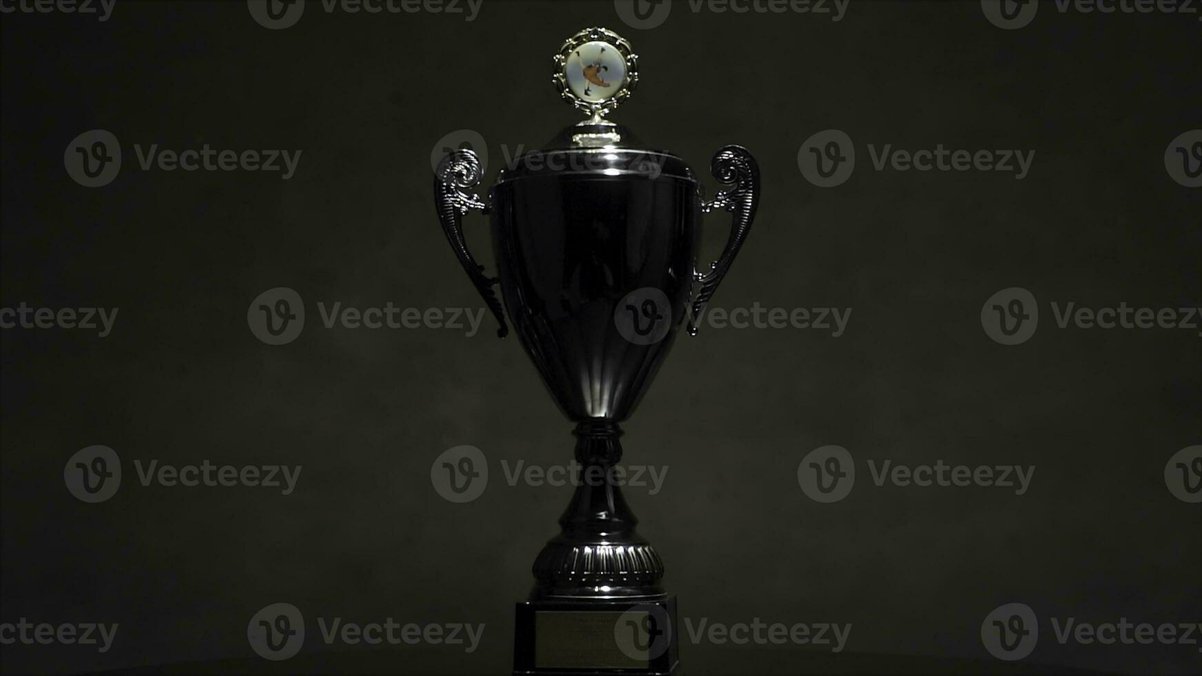 Champion golden trophy placed on wooden table with dark background copy space ready for your design win concept. still life image of trophy shot in the studio. champion golden trophy on wood table photo