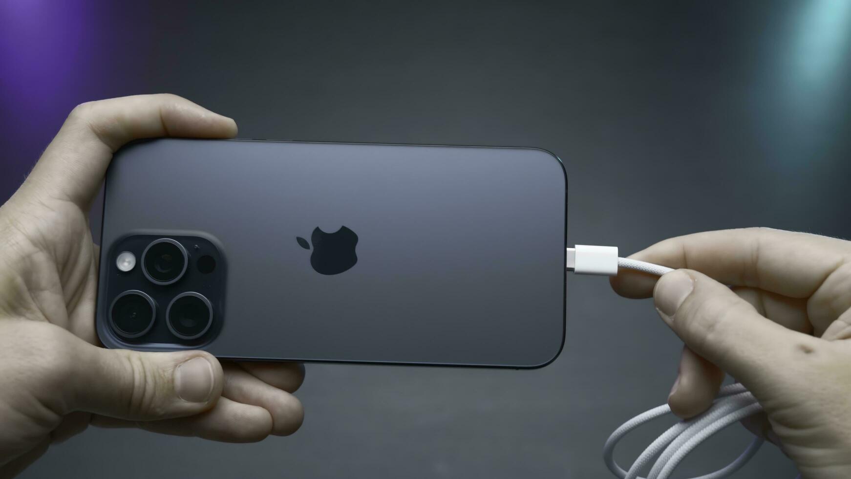 China, Beijing - September 15, 2023.Wire type C in new iPhone. Action. USB-C connector in new iPhone model 15 pro. Flagship in world of iPhones with new Type C charging connector in model 15 pro photo