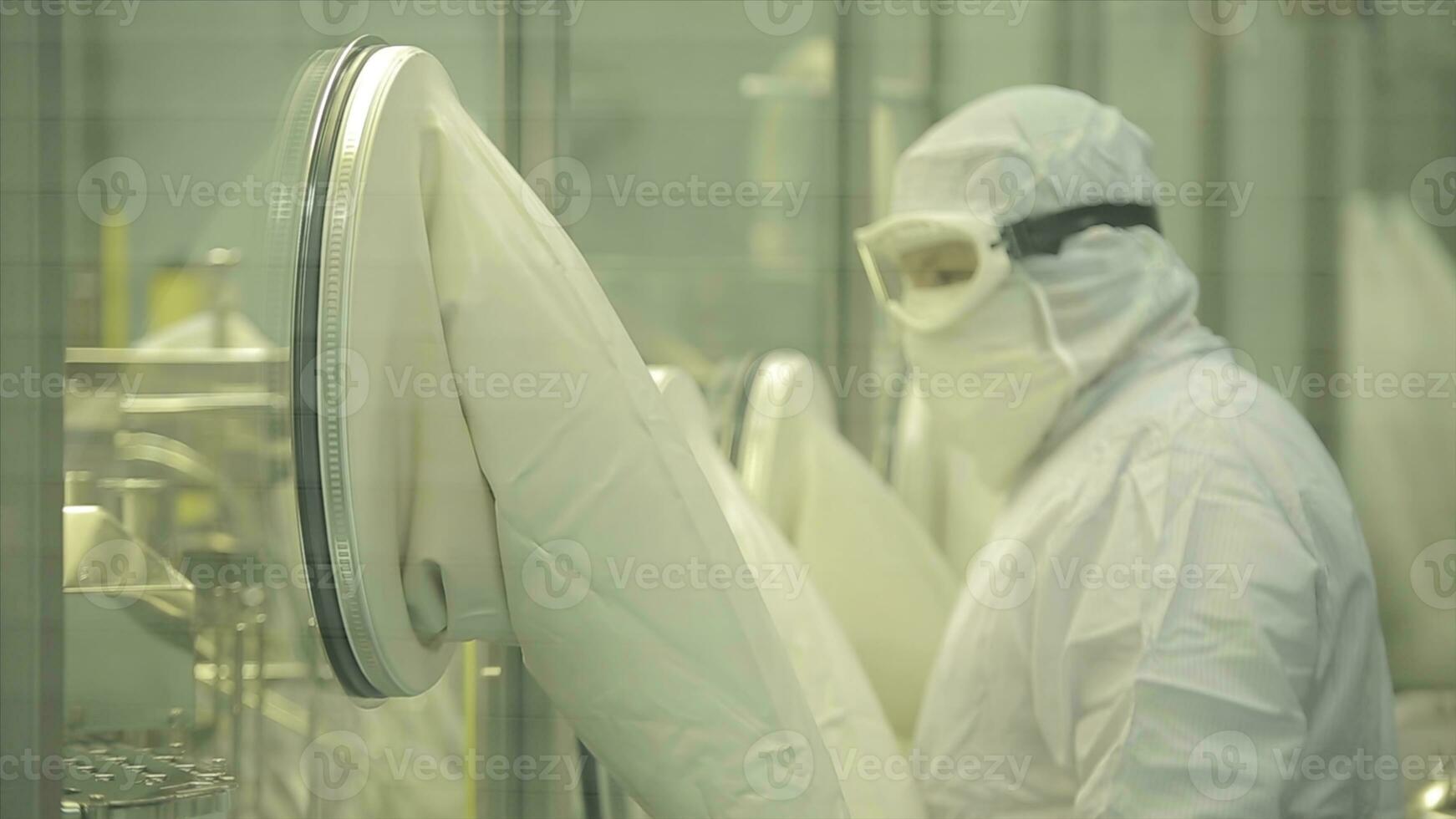 Pharmaceutical industry. Male factory worker inspecting quality of pills packaging in pharmaceutical factory. Automatic tape to create packaging and filling of medicines. control in the factory of photo