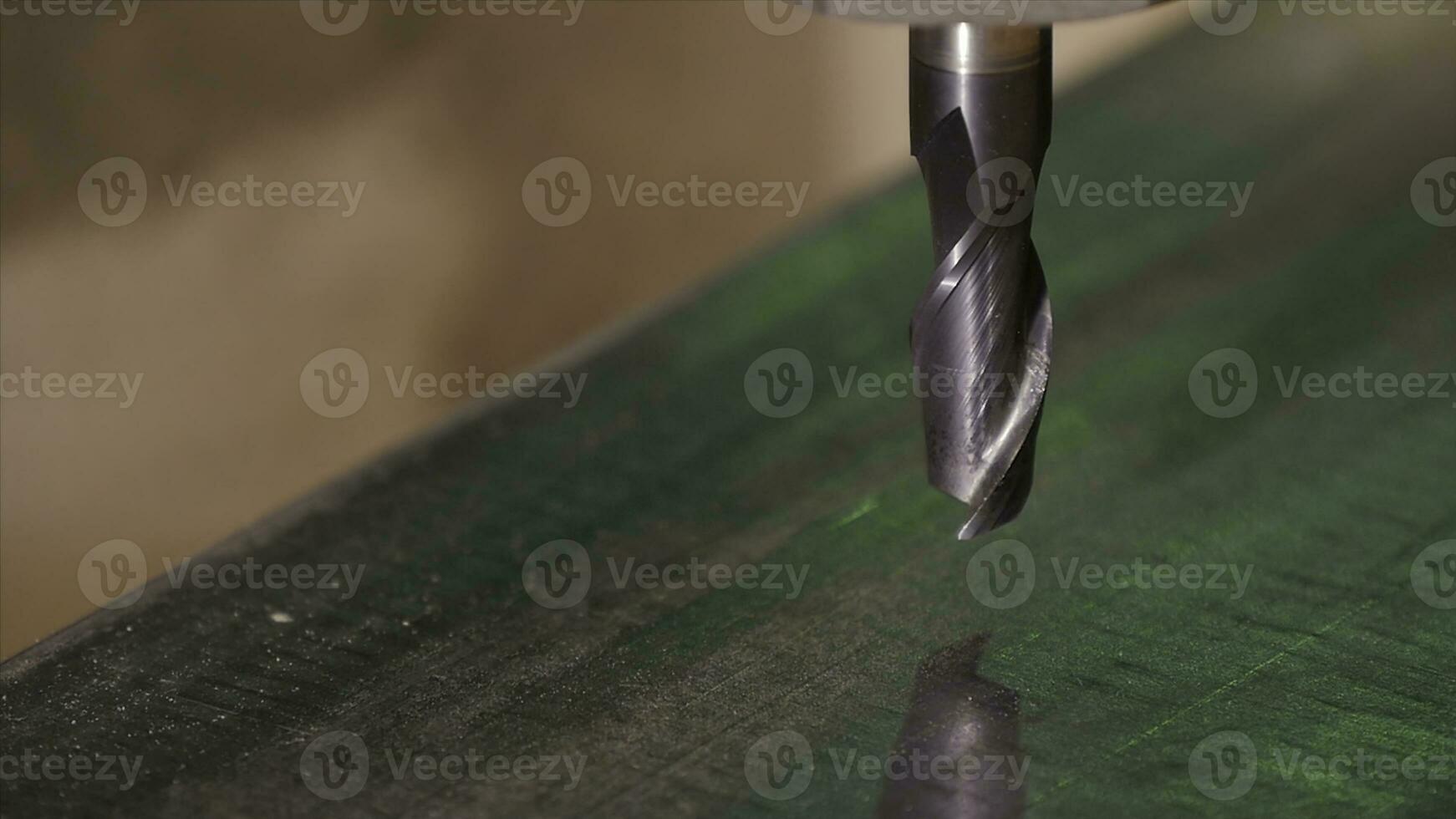 Hole being drilled into metal. Drilling closeup in metal workshop. Employee drill in flat steel plate with bench drill. Industry in slow motion photo