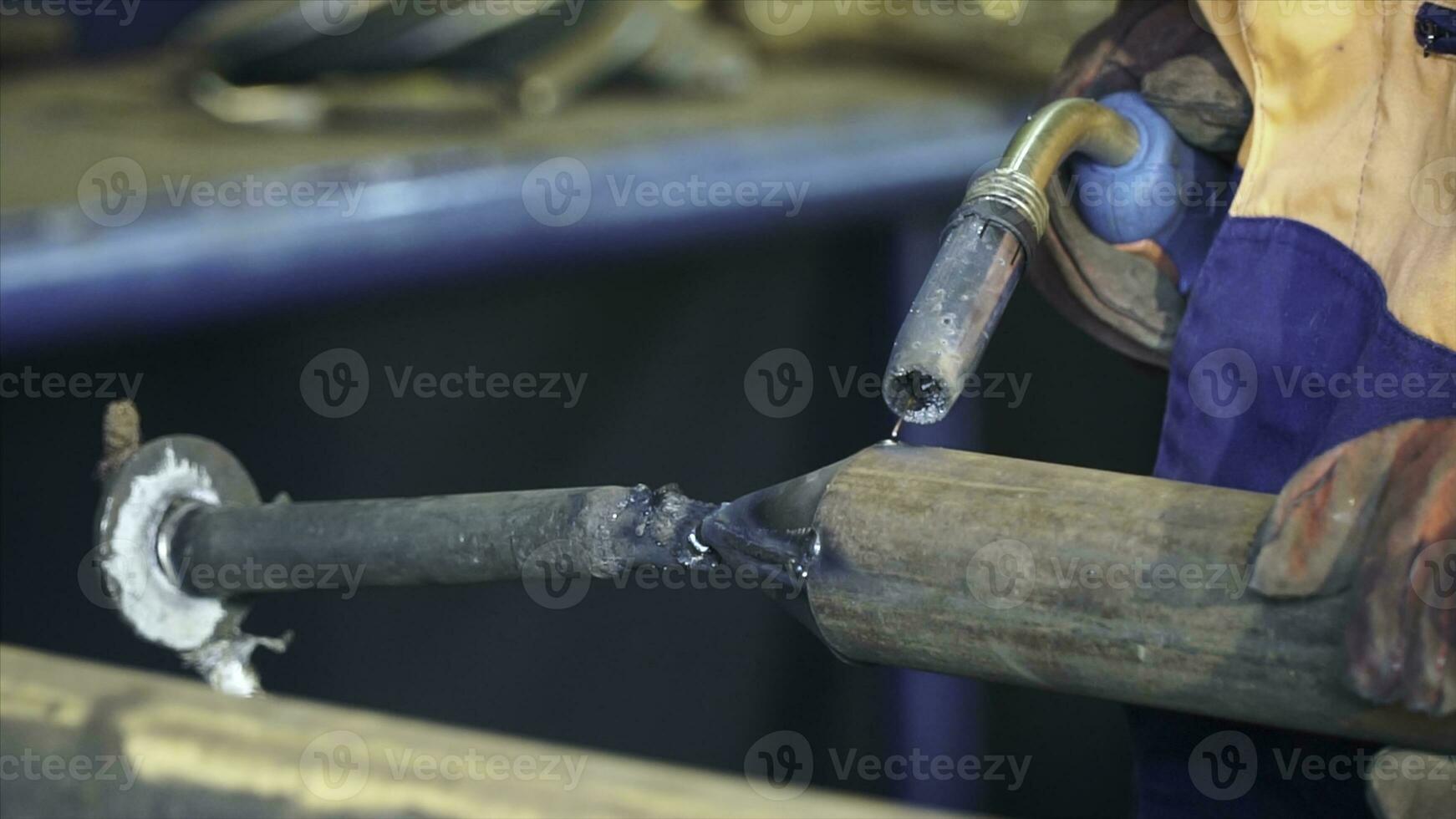 Industrial Worker at the factory welding close up. Electric wheel grinding on steel structure in factory. Welding work photo