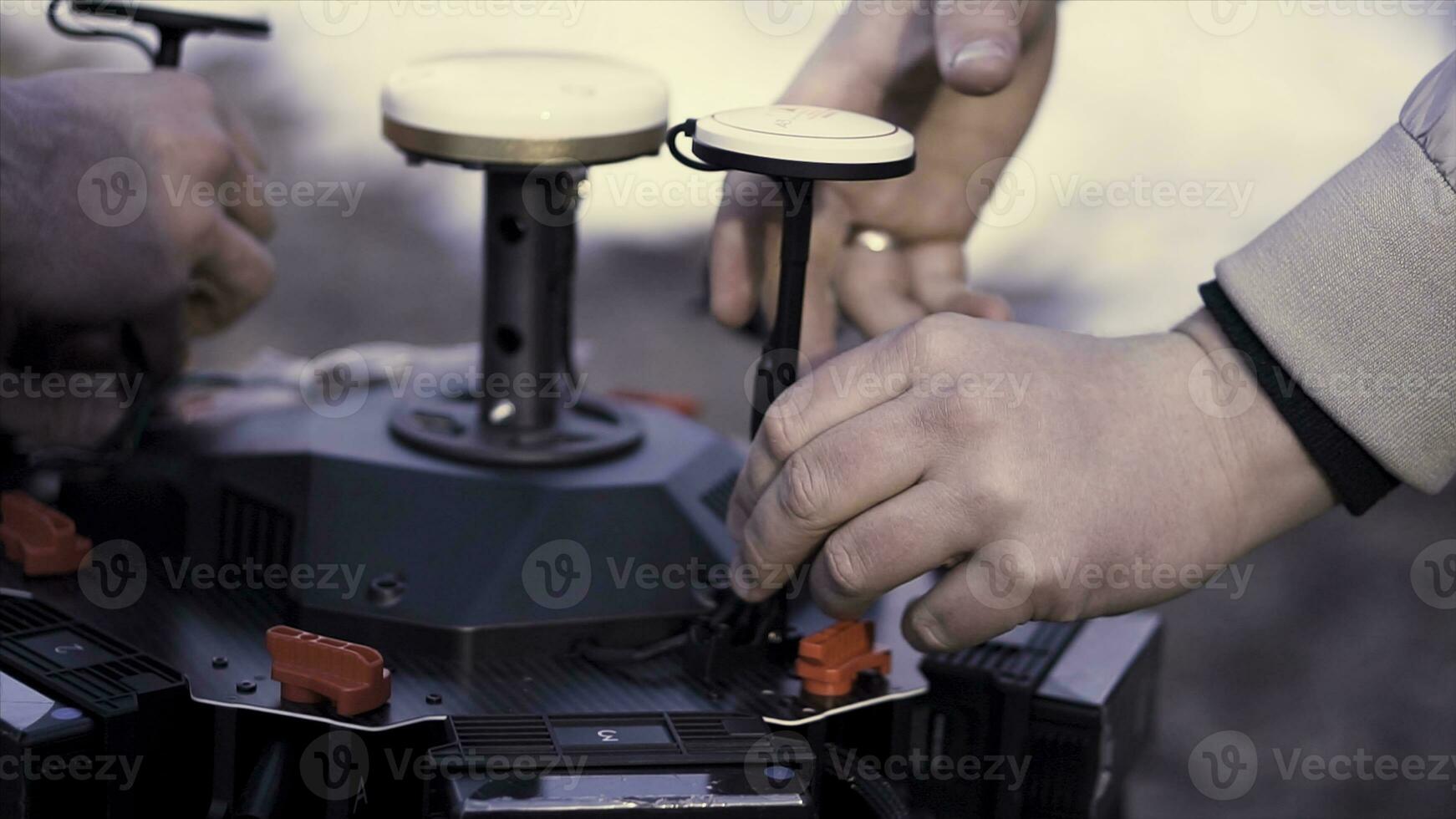 Close up for hands performing assembly of the device for quadcopter filming, modern technologies concept. Clip. Preparation of space orientation system for drone. photo