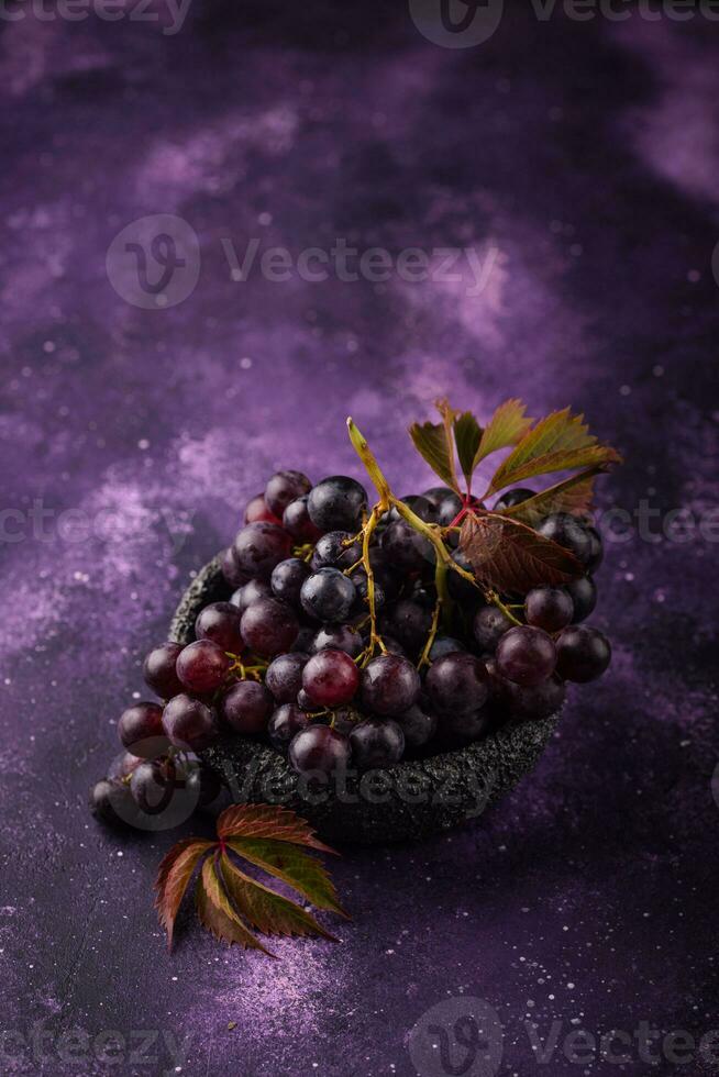 Purple grapes on violet background photo