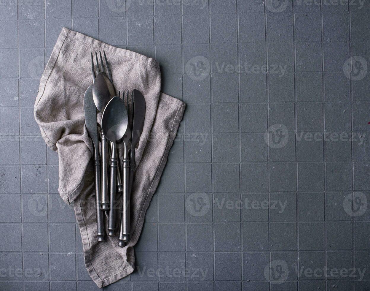 Craft iron tableware in grey background photo