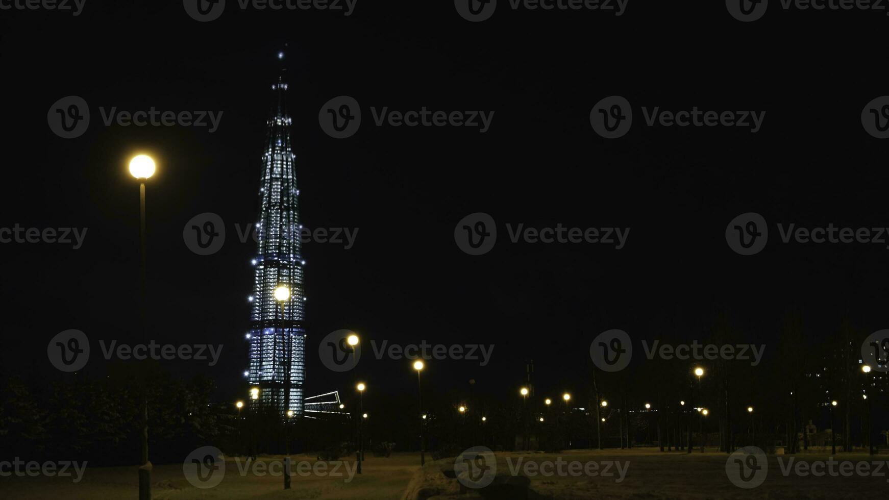 View from the bottom on the beautiful skyscraper Lahta center at night designed by award winning British Architect Tony Kettle. Concept. The Europe's highest tower photo
