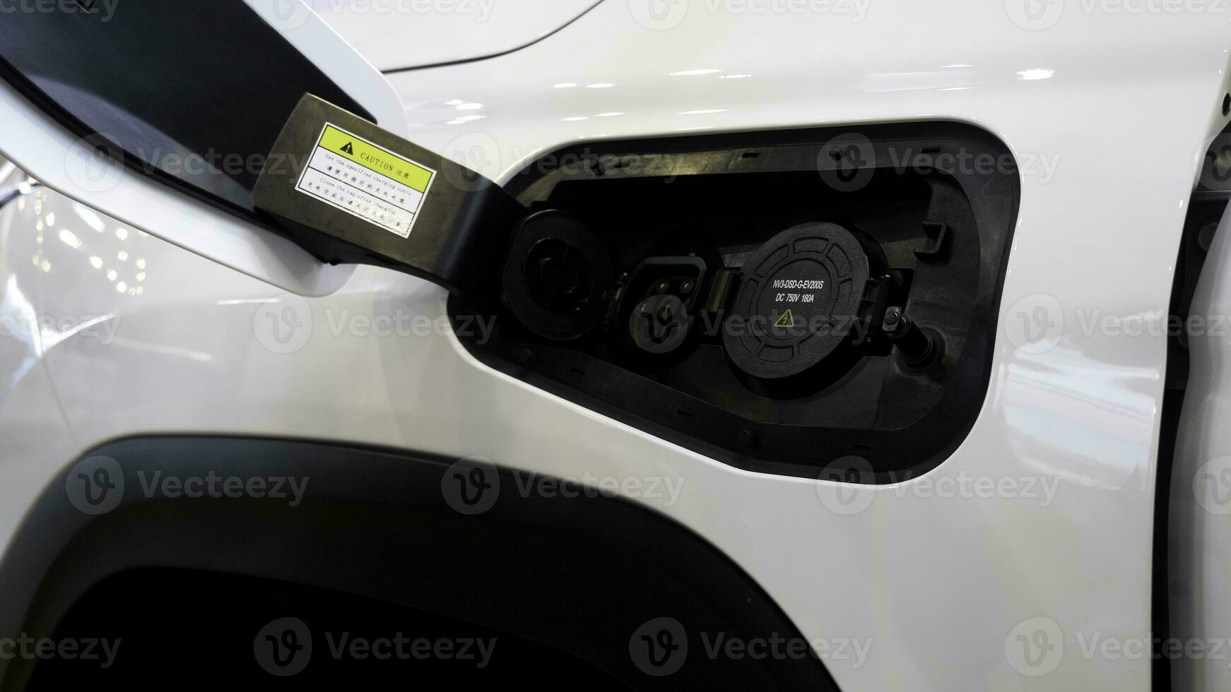 Charging for an electric car. Media.A white car at a special gas station where electric cars are charged. photo