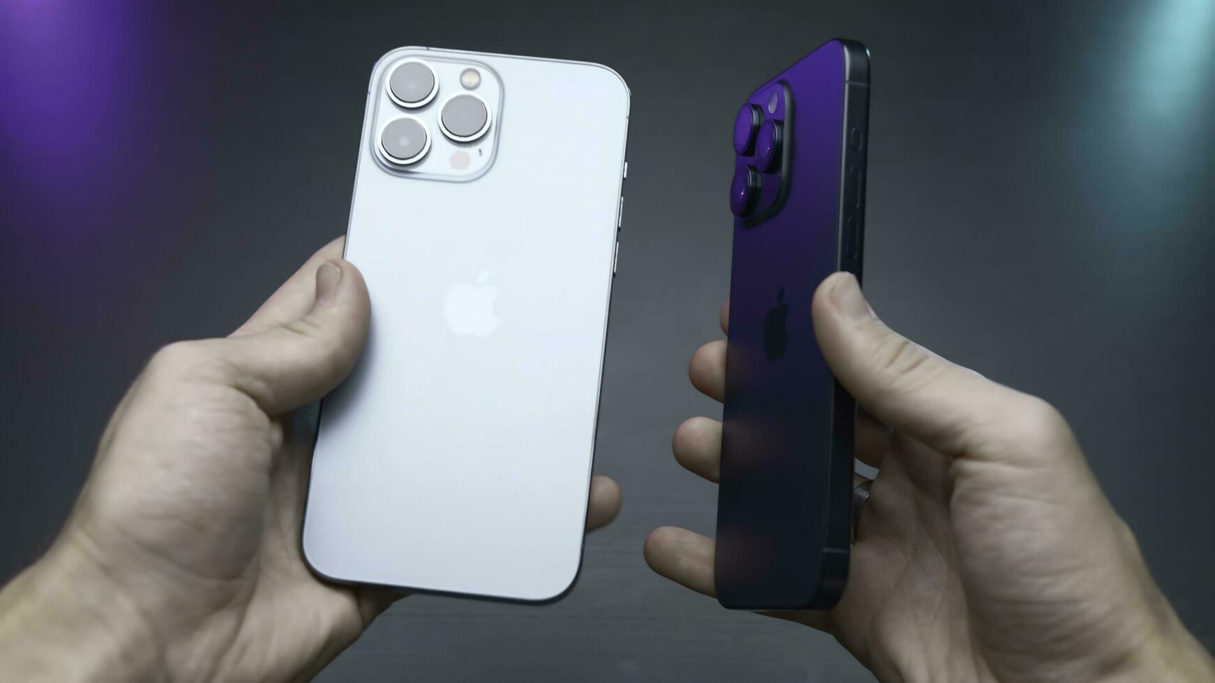 USA, New York - September 15, 2023. Comparison of new iPhones. Action. Blogger compares latest versions of iPhones 14 and 15 pro. Comparison of external design of iPhones 14 and 15 pro photo
