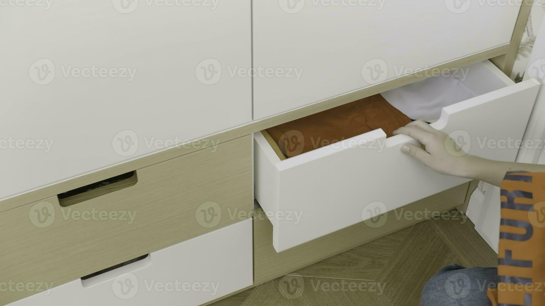 Order. Creative . A small white bedside table in which things, hoodies, etc. are stacked, it is opened and clothes are taken out. photo