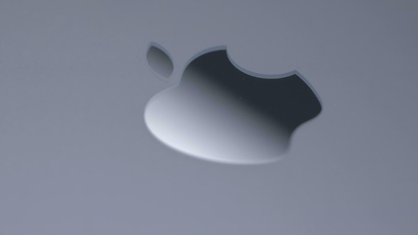 USA, New York - September 15, 2023. Close-up of Apple logo on gray background. Action. Stylish apple logo with shiny surface. Apple logo on MacBook or new iPhone photo