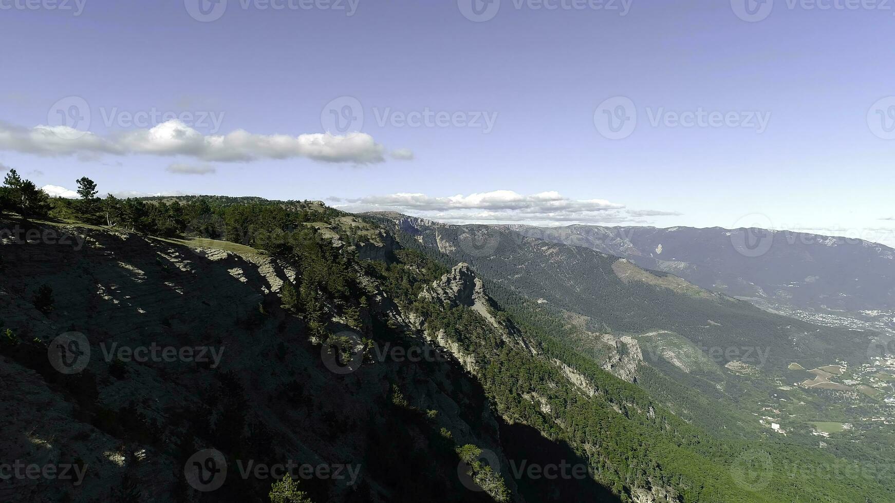 Aerial view of the forest in a mountainous area. Shot. Clean beautiful green forest on a Sunny day photo