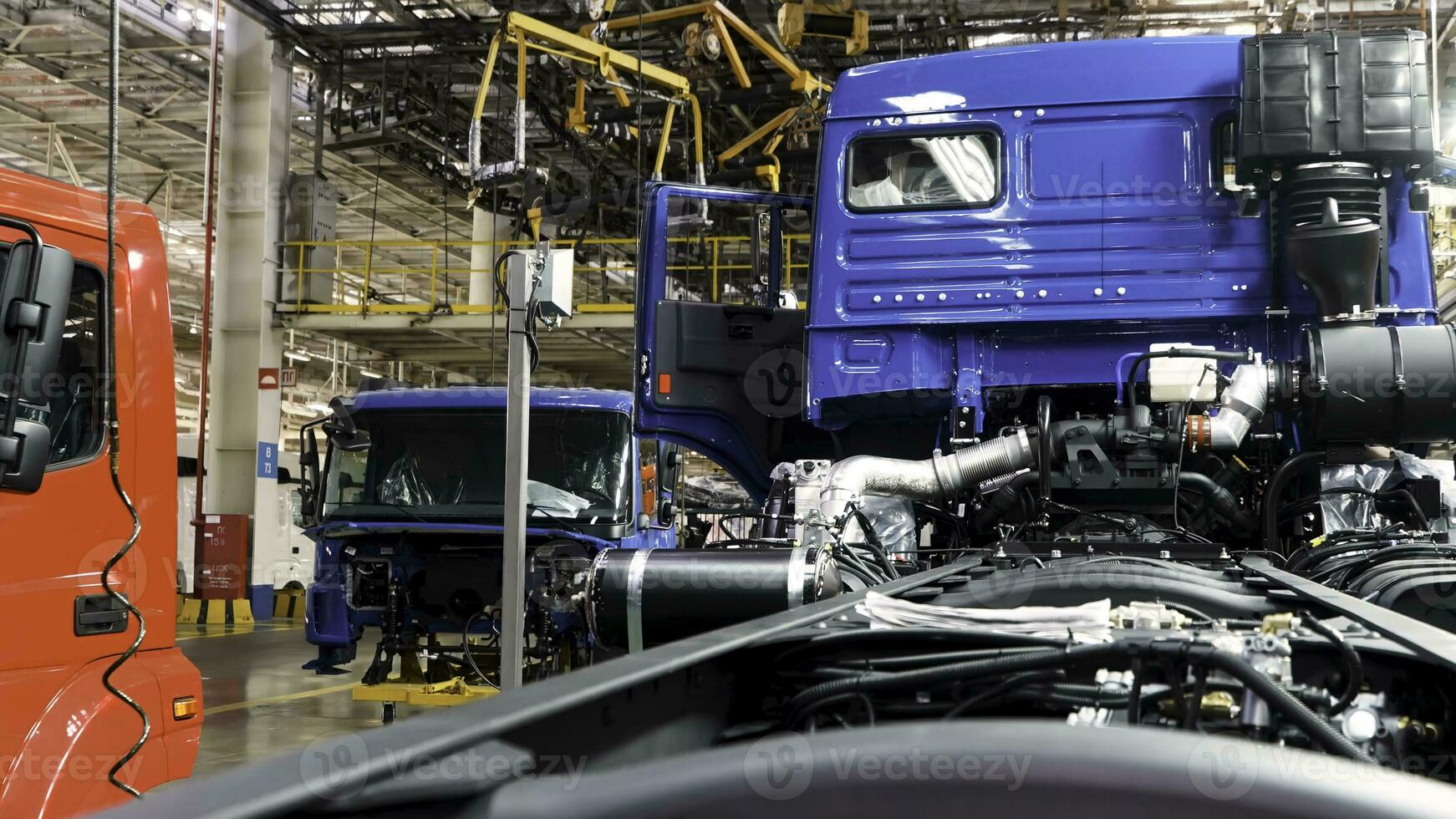 Automobile assembly line production at the Kamaz truck factory. Scene. Time lapse effect, industrial background with body frame hanging line, mechanical engineering concept. photo