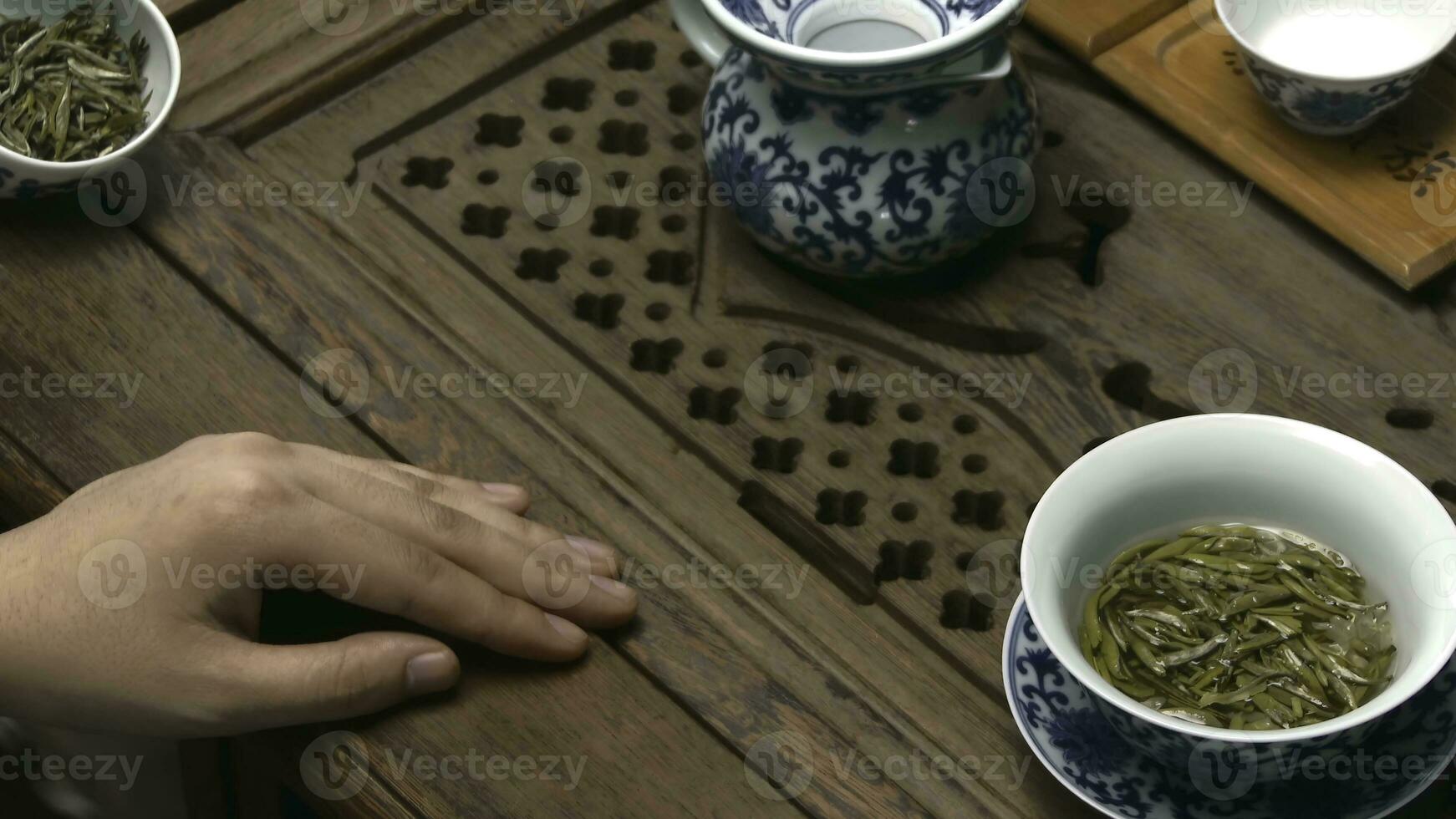 Chinese tea ceremony is performed by tea master. Chinese tea ceremony. Female hands pouring tea into cups photo