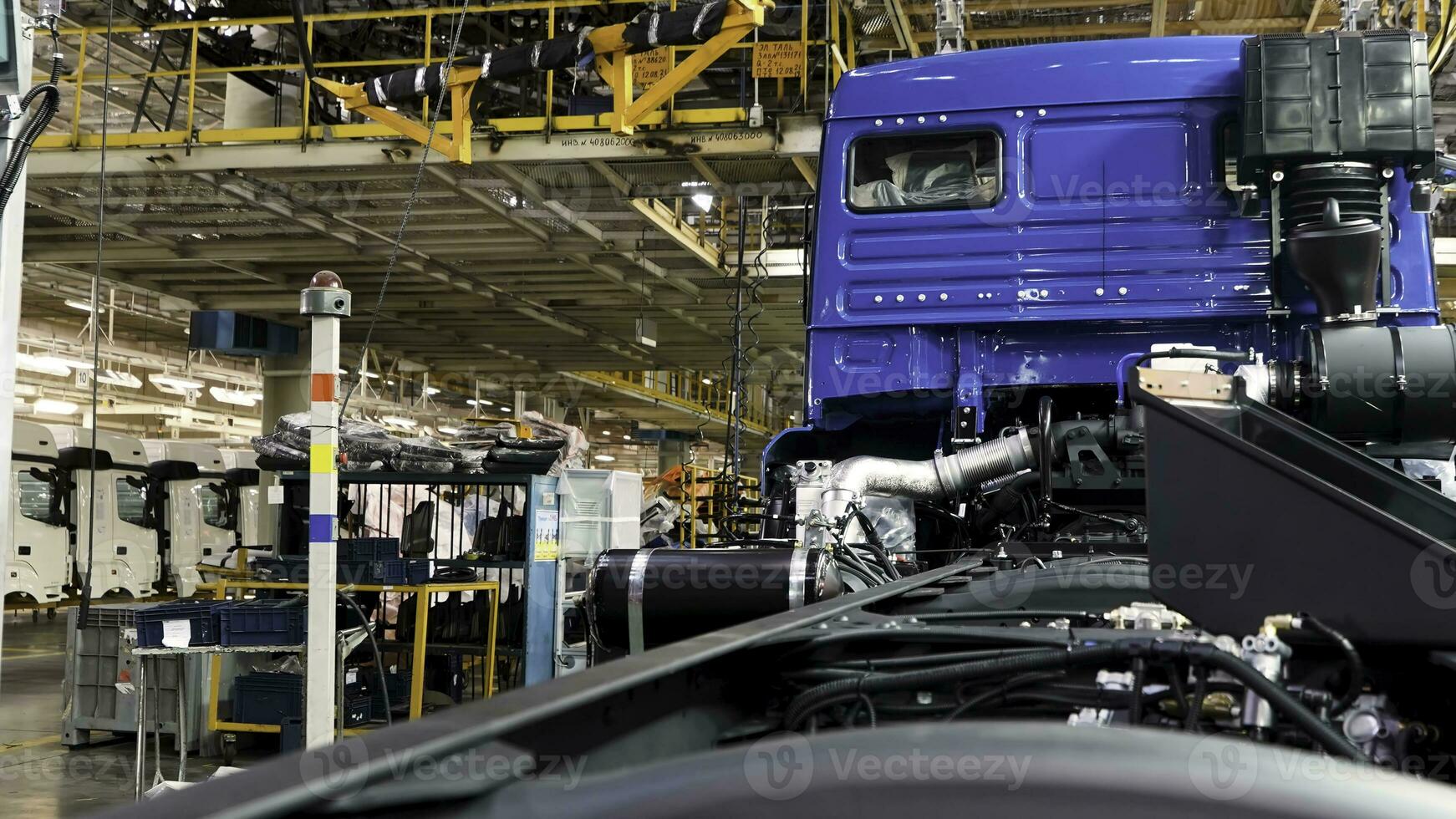 Automobile assembly line production at the Kamaz truck factory. Scene. Time lapse effect, industrial background with body frame hanging line, mechanical engineering concept. photo