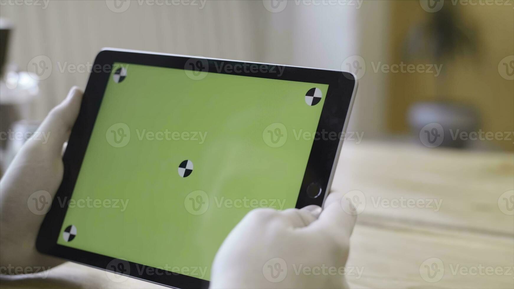 Technology, mockup and internet concept, chroma key screen for placement of your own content. Stock footage. Young woman looking at the computer tablet with the chroma key green screen. photo