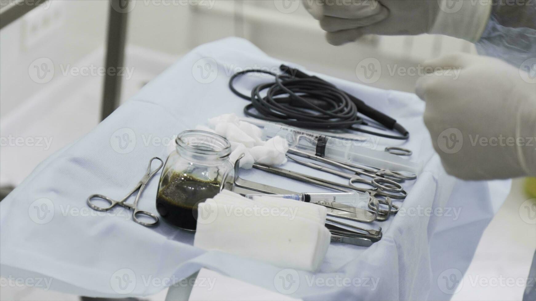 Close up of sterile surgical tools for laparoscopic surgery. Action. Tools for medical surgery with the glass bowl of iodine, concept of health and medicine. photo