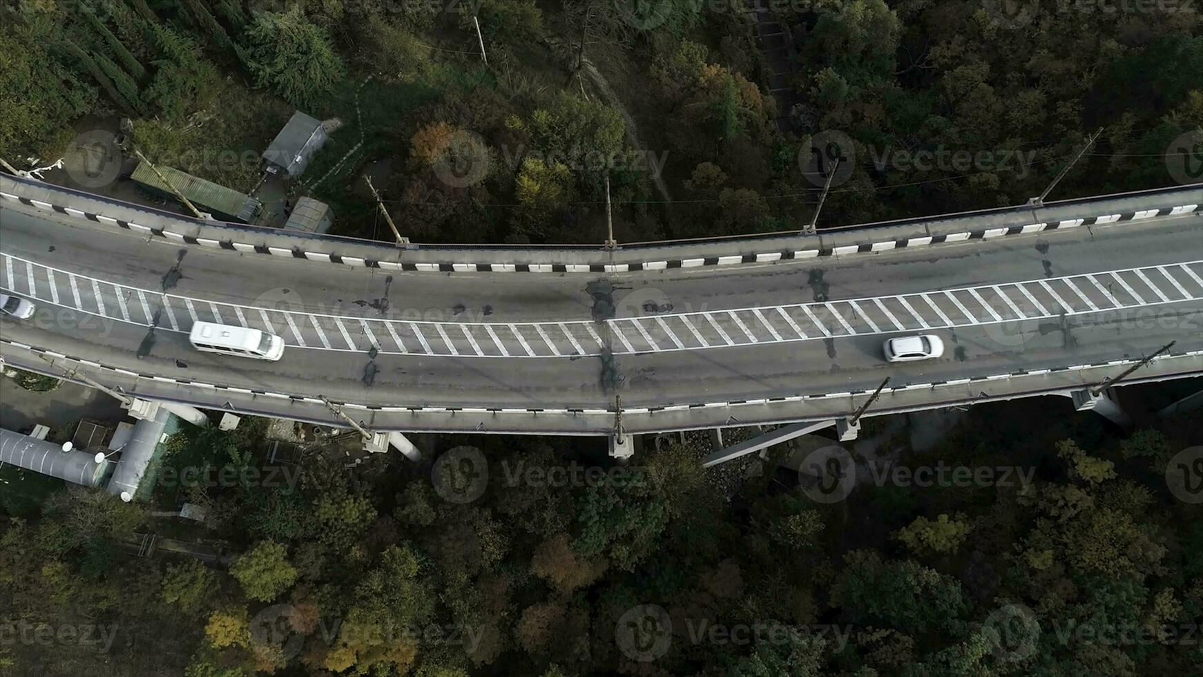Top view on overpass with driving cars, sea and beautiful landscape background. Aerial view of highway and overpass in city. Road junctions photo