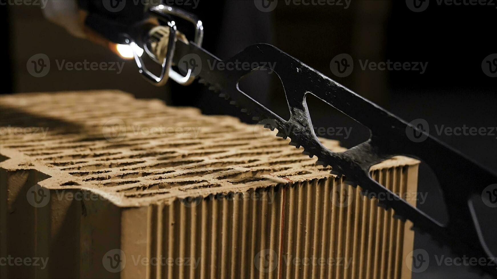 Close up of electric cutting machine for small ceramic blocks turning on before cutting. Stock footage. Worker uses automatic saw to cut ceramic blocks. photo