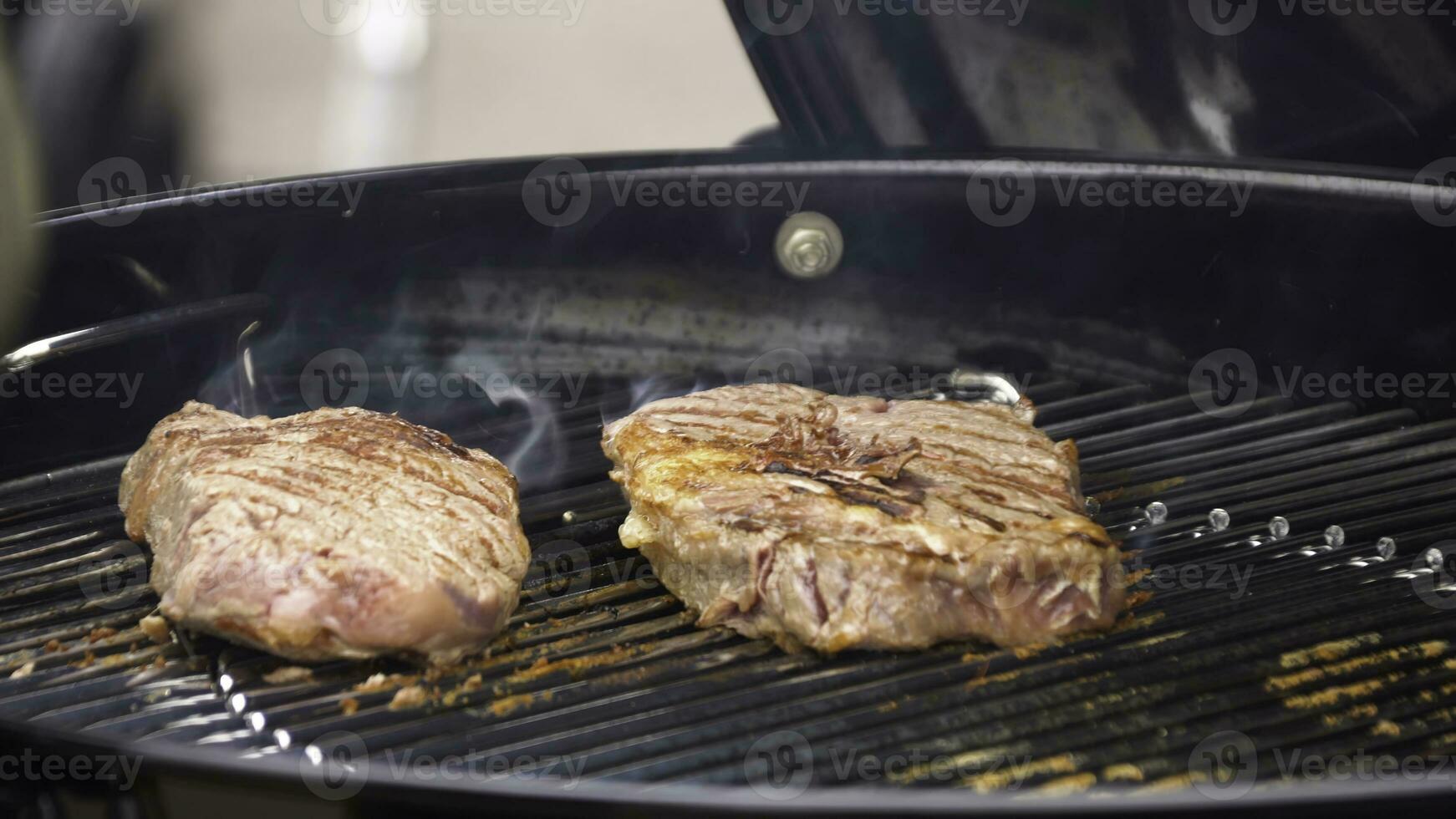 Beef steaks on the grill with flames. Cooking steaks on the coals. Concept of eating meat photo