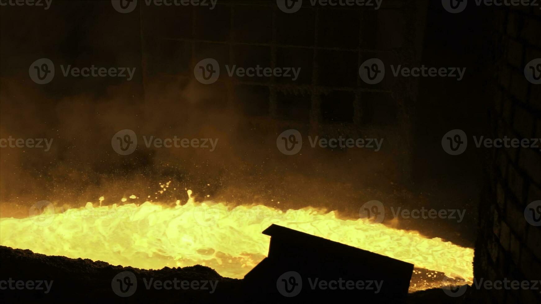 Liquid metal from blast furnace. Liquid metal pouring stream photo