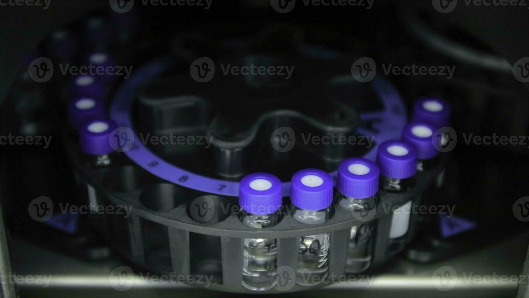 Scientist putting small tube to machine in laboratory. centrifuge laboratory medicine. A centrifuge spins vials of liquid in a laboratory test. Pharmaceutical industry. Medicine manufacturing and lab photo