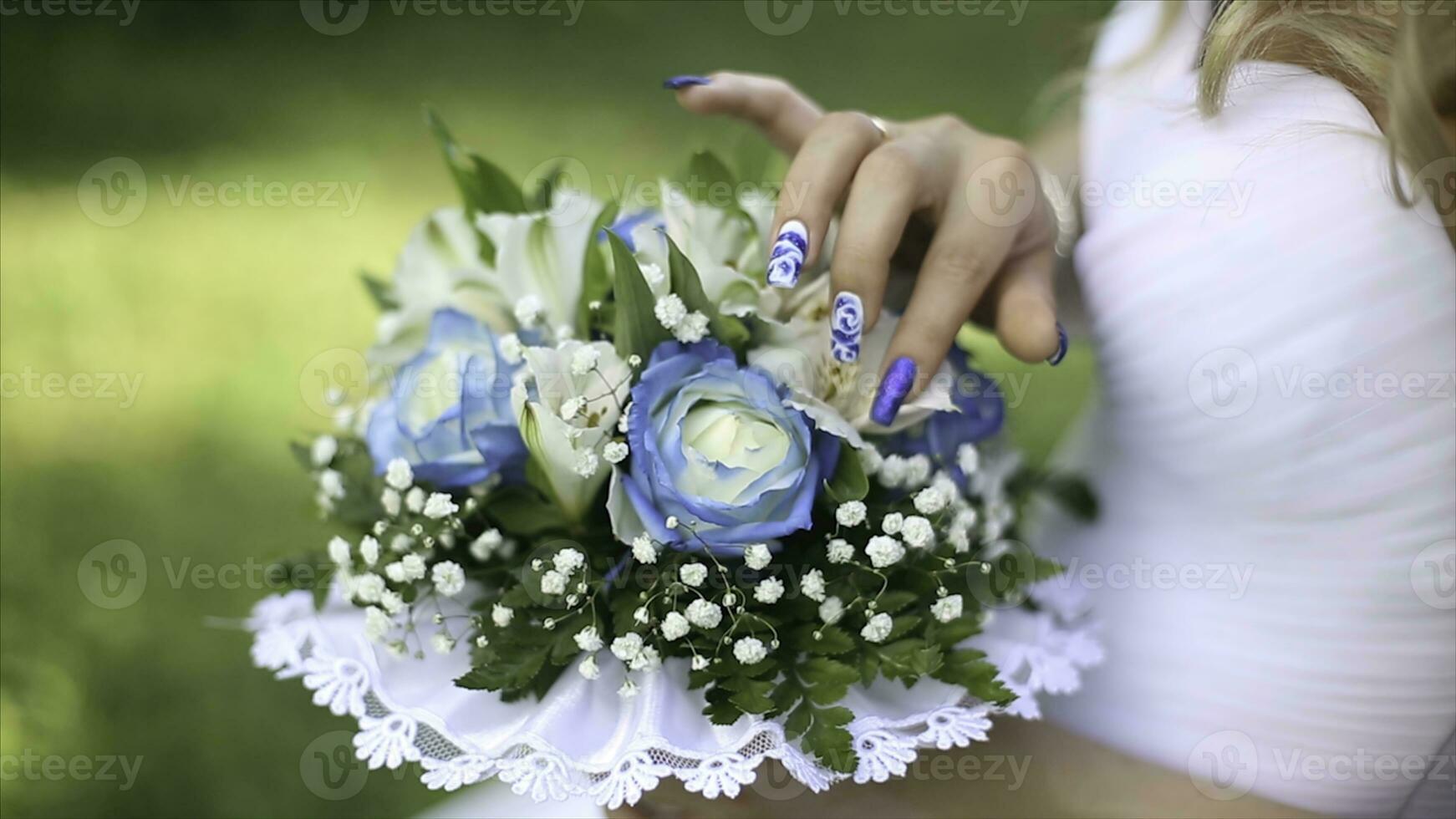 Beautiful bouquet of different colors in the hands of the bride in a white dress. Bride in white dress with bouquet Black woman holds wedding bouquet. Wedding photo