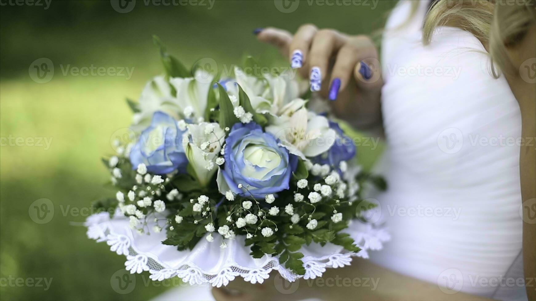 Beautiful bouquet of different colors in the hands of the bride in a white dress. Bride in white dress with bouquet Black woman holds wedding bouquet. Wedding photo