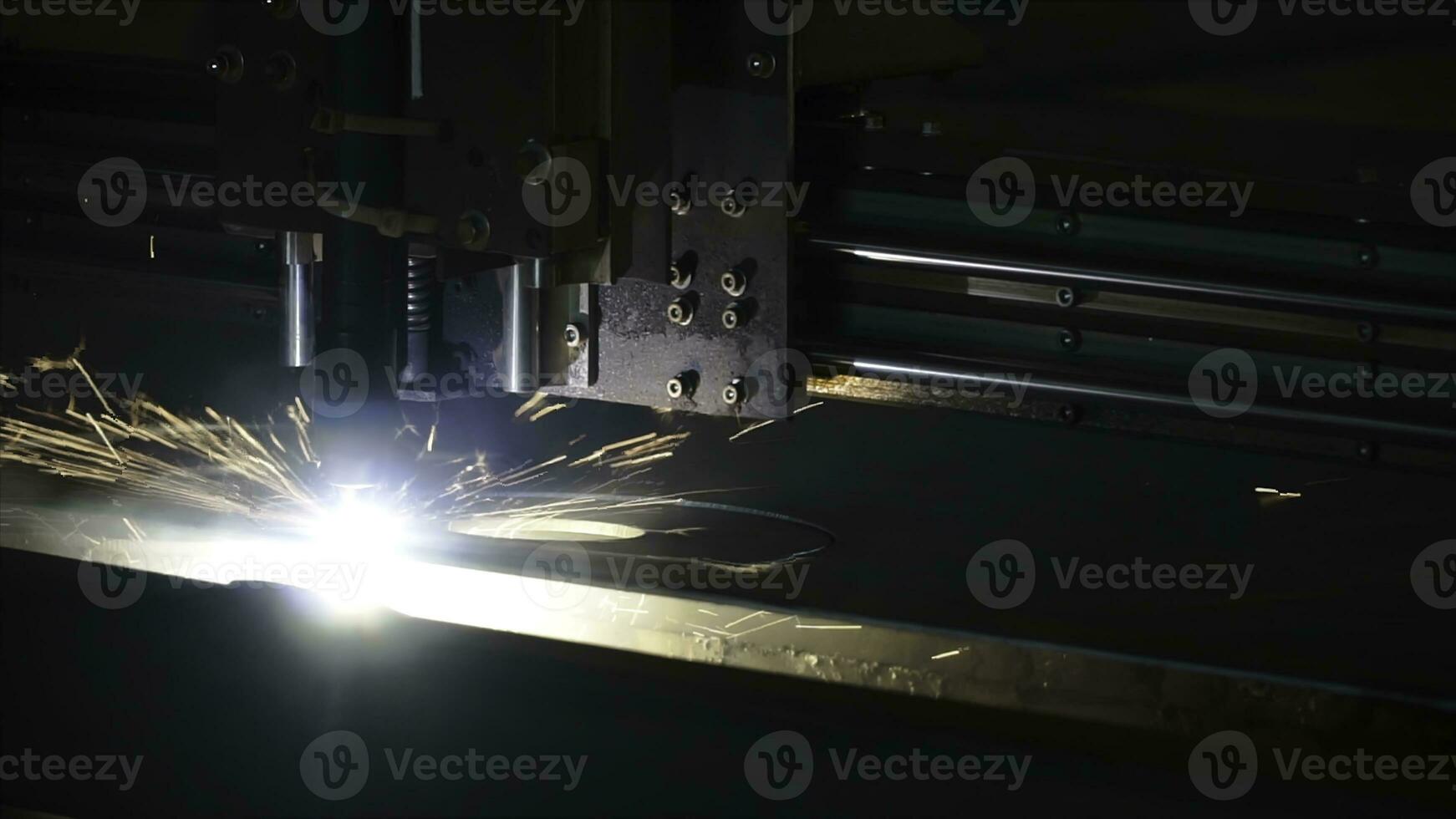 Laser cutter for manufacture. Clip. The laser cutter machine while cutting the sheet metal with the sparking light photo